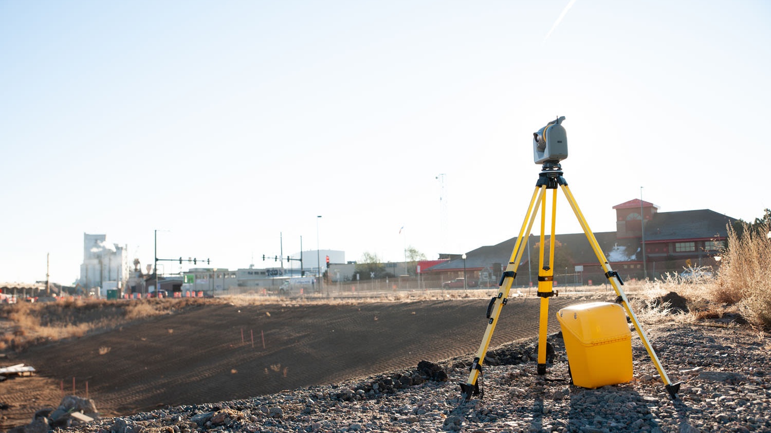 Setting out engineer using a robotic total station to mark precise positions on a construction site